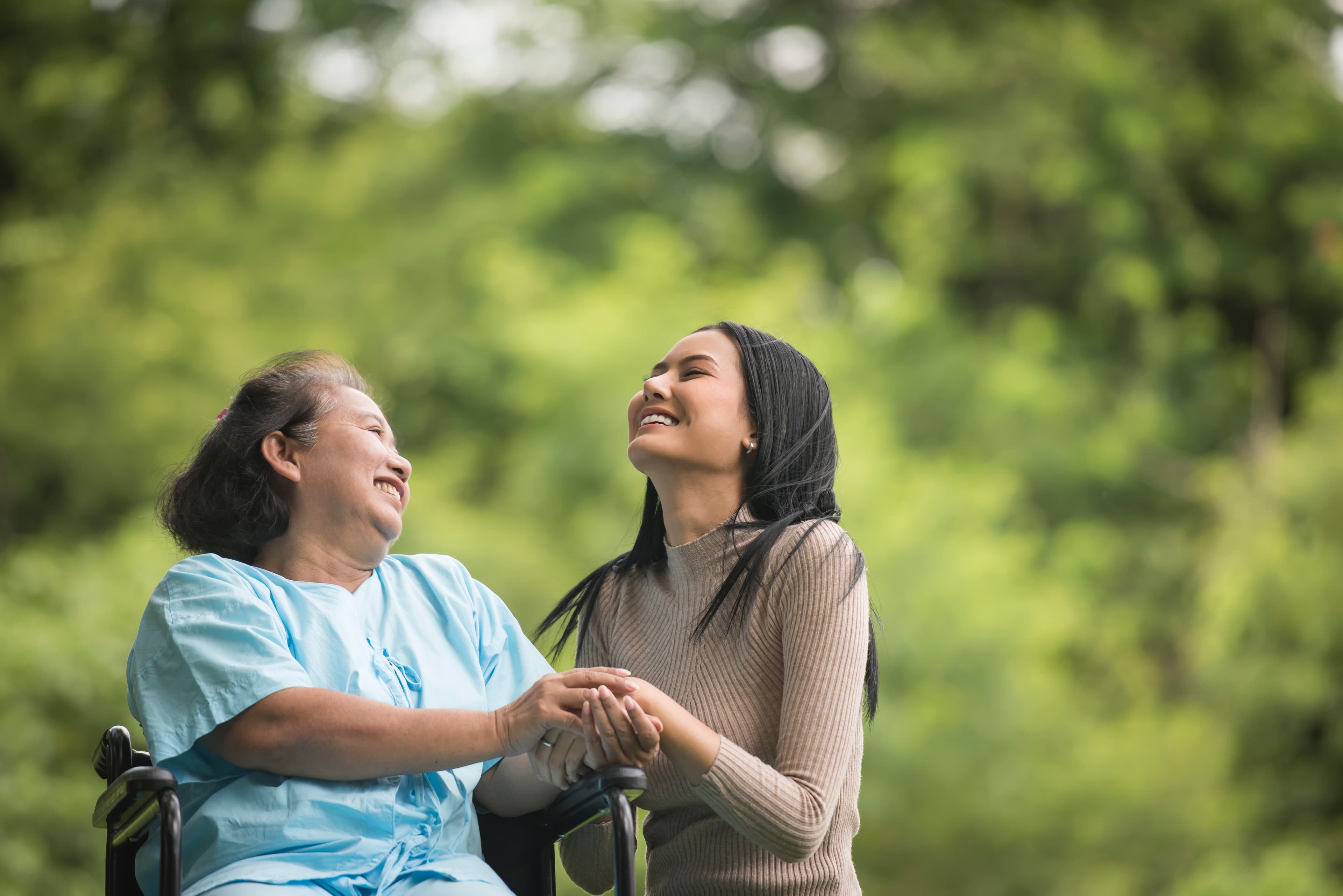 Family member sharing a joyful moment with elderly loved one