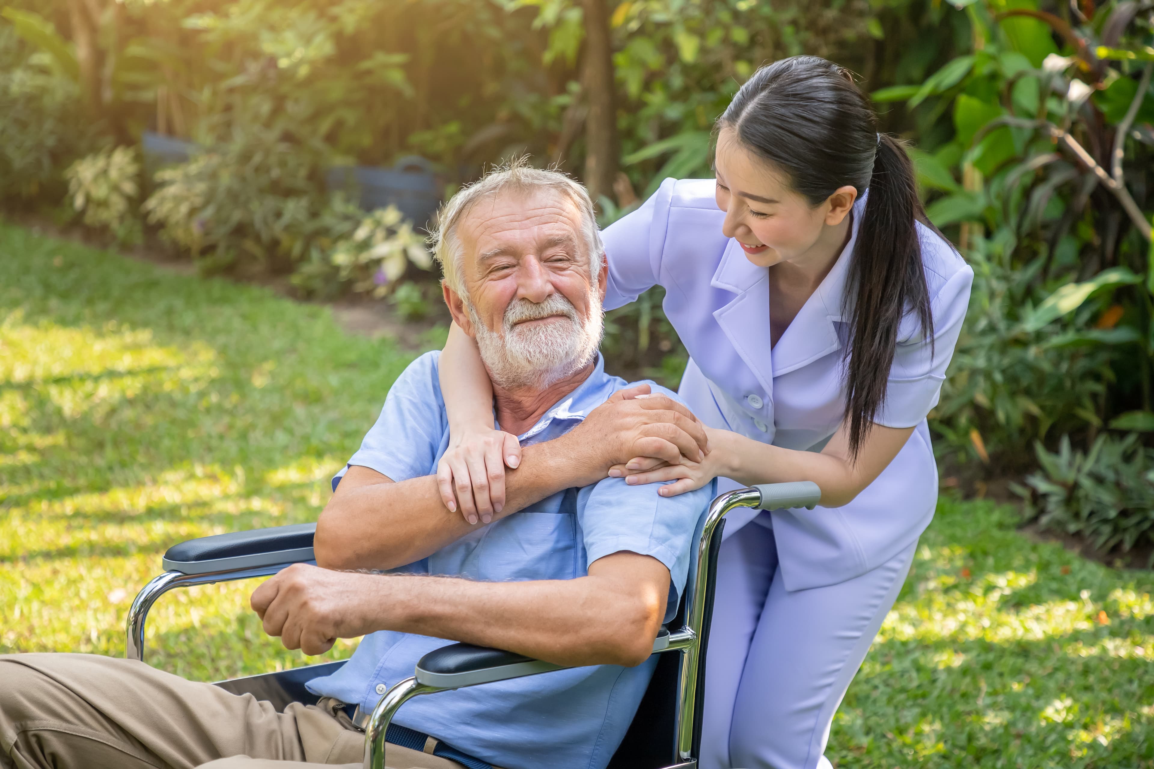 Caregiver with elderly client enjoying time outdoors